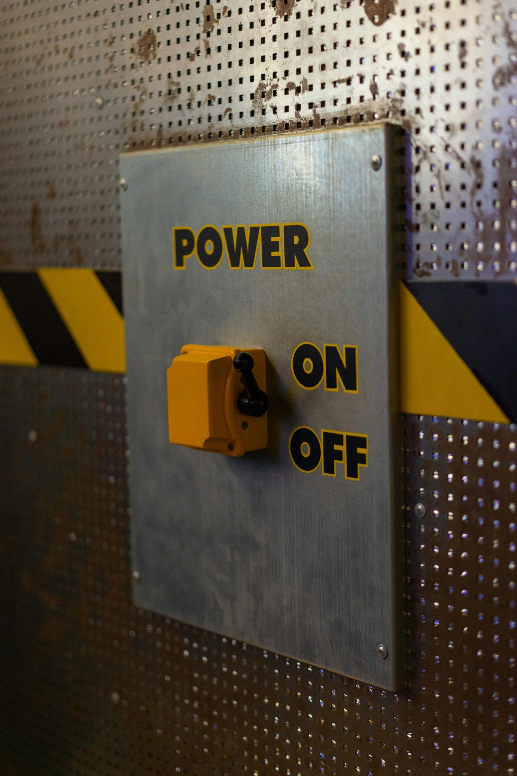 A close-up of a metallic industrial power switch panel with on and off labels.